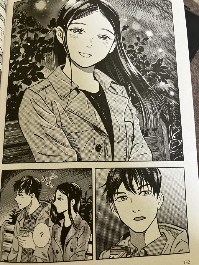 Dark-haired woman in a blazer smiles. Dark-haired man blushes while looking at her.