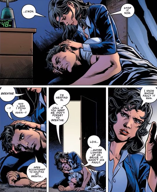 A woman hugs a man lying on the floor, trying to comfort him with words