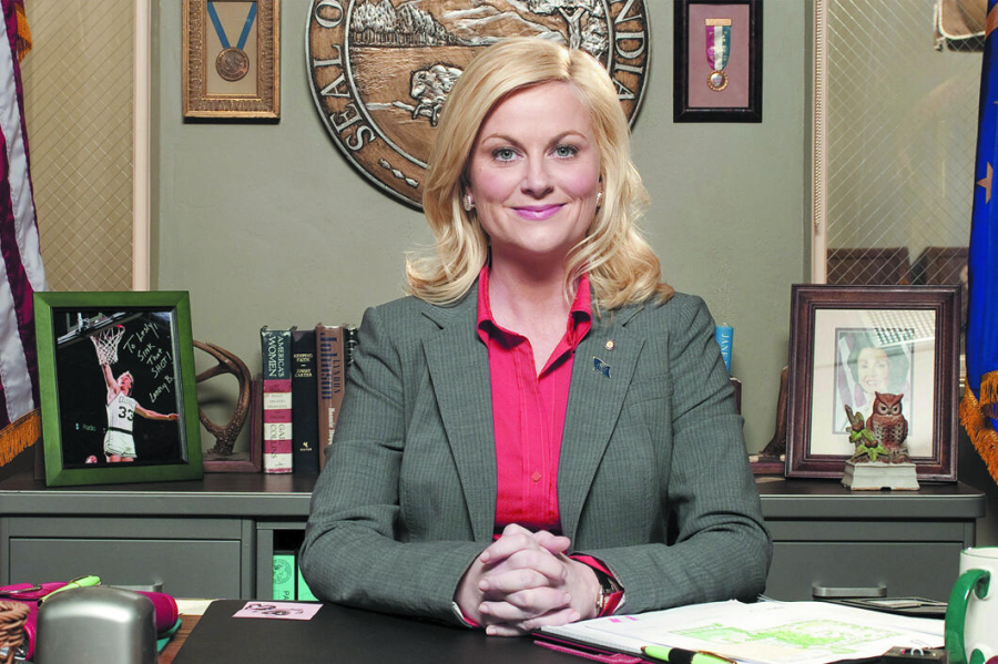 White blonde woman sits in a government office