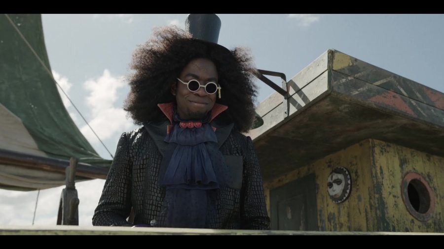 Black man with afro and sunglasses looks past the camera