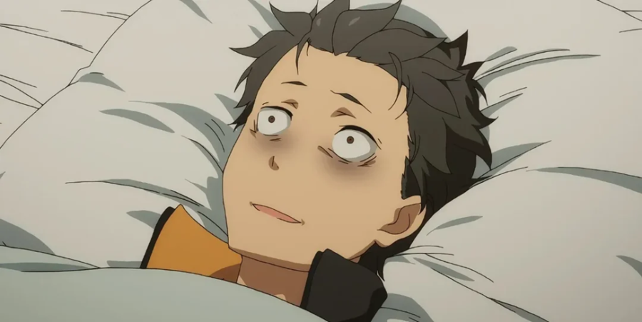 White man lies on a pillow with a shocked expression and bags under his eyes