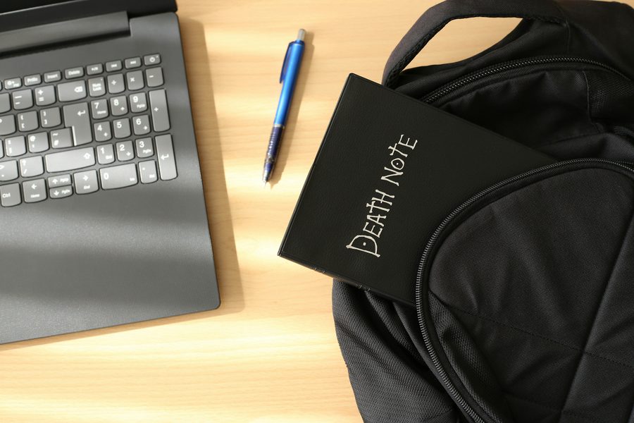 A Death Note peaking out of a backpack